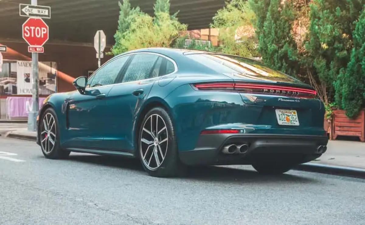 A sleek blue luxury sedan parked on a residential street.