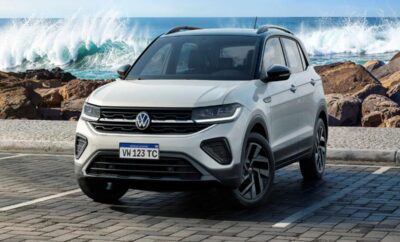 White Volkswagen SUV parked outdoors with a scenic ocean backdrop.