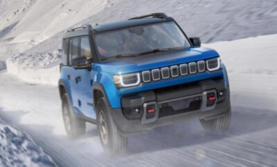 Blue SUV driving on a snowy road.