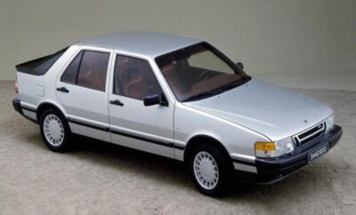 A silver four-door sedan parked on a plain surface.