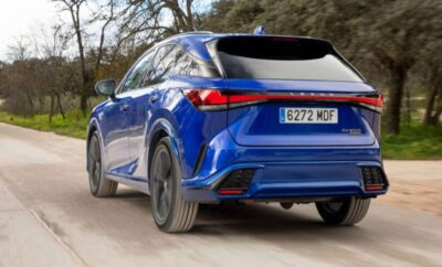 Blue electric SUV driving on a dirt road with a modern design.