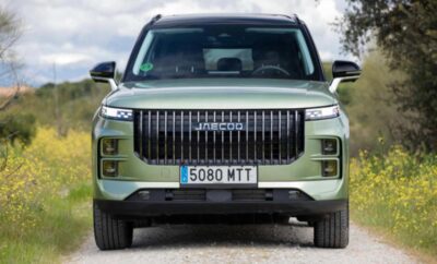 Front view of a green luxury GMC SUV with vertical grille and license plate 5080 MTT.