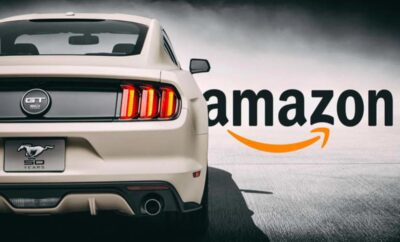 Rear view of a white sports car with Amazon logo in the background.