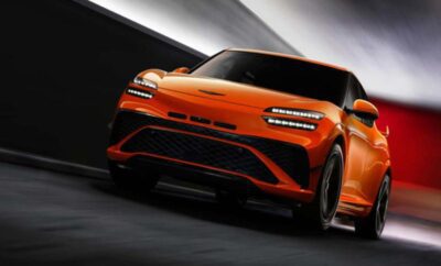 Sleek orange sports SUV speeding on a dark road.