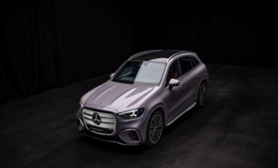 Sleek silver Mercedes-Benz SUV showcased in a dark studio.