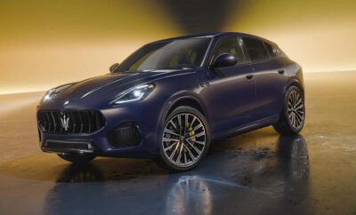 Sleek dark blue luxury SUV with striking yellow accents on wheels.