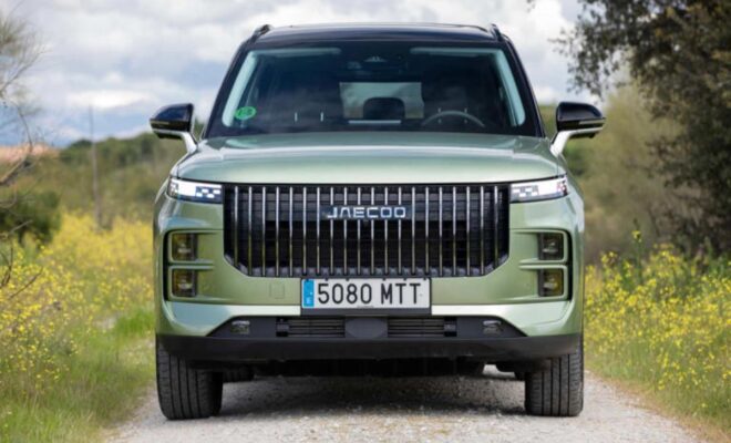 Front view of a green luxury SUV with a prominent grille and license plate 5080 MTT.