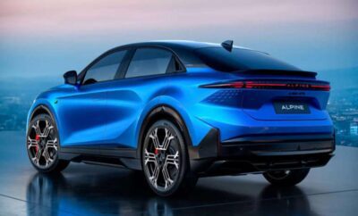 Sleek blue electric SUV parked with a scenic sunset backdrop.