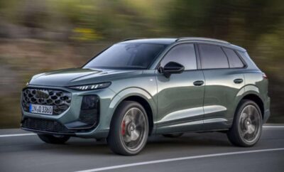 A sleek, modern SUV driving on a road with motion blur.