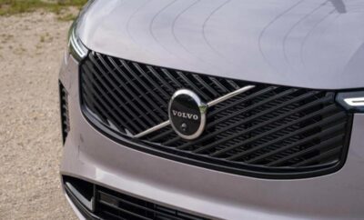 Close-up of a silver Volvo car grille with the Volvo logo.