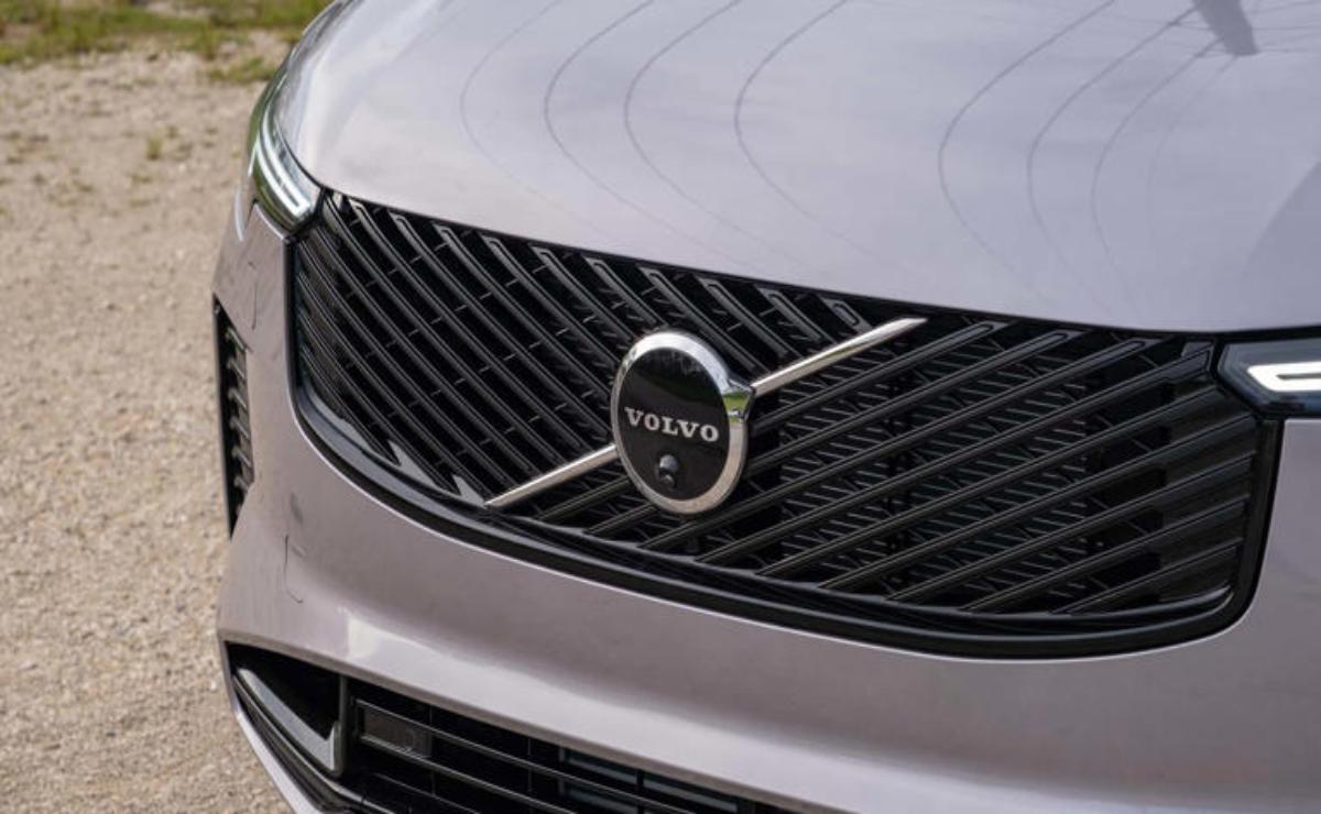 Close-up of a silver Volvo car grille with the Volvo logo.