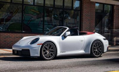White luxury convertible sports car parked on the street.
