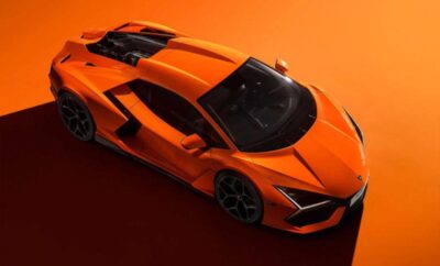 Sleek orange sports car with sharp design on an orange background.