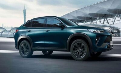 Sleek dark green SUV parked near a modern building.