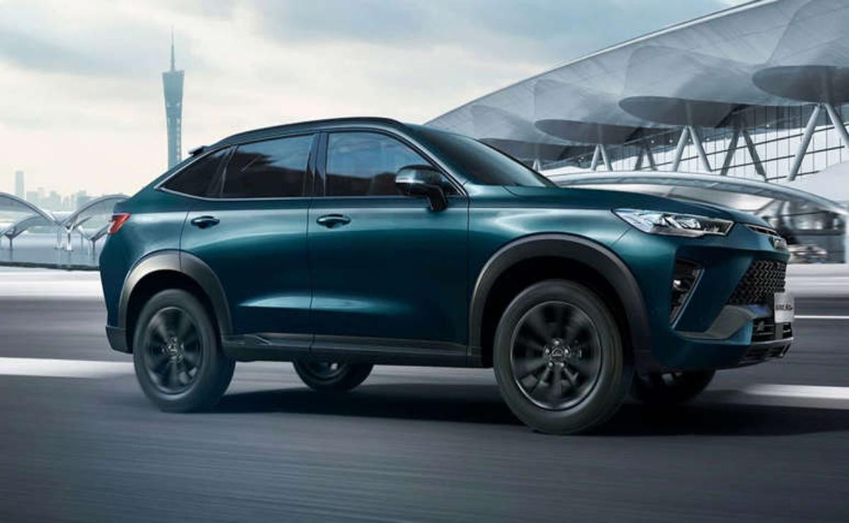 Sleek dark green SUV parked near a modern building.