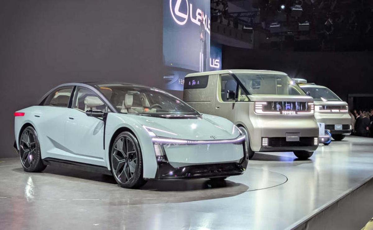 Two modern electric cars displayed at an auto show.