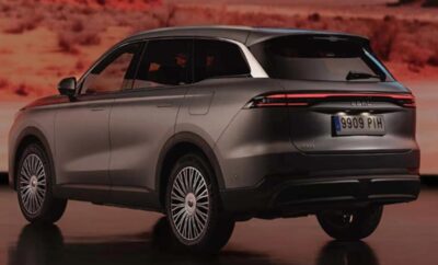 A sleek silver SUV parked on a reddish terrain at dusk.