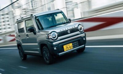 Compact silver SUV driving on a road with motion blur.