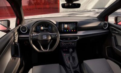 Modern car interior with touchscreen and multifunction steering wheel.