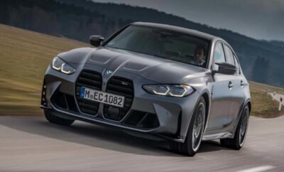 A sleek gray BMW sports car driving on a road.
