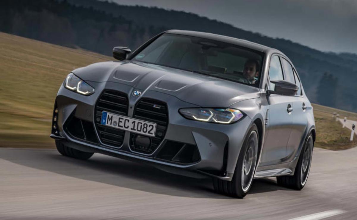 A sleek gray BMW sports car driving on a road.