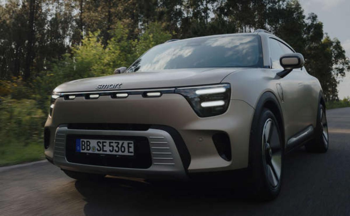 A modern gray electric SUV parked outdoors on a cloudy day.