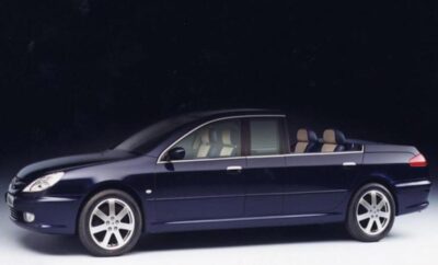 Side view of a sleek black sedan with beige interior.