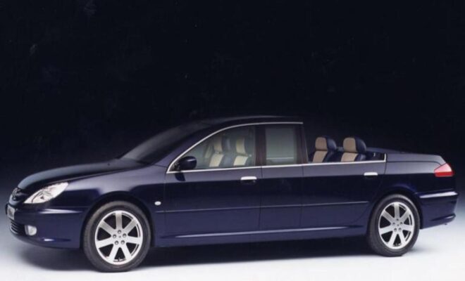Side view of a sleek black sedan with beige interior.