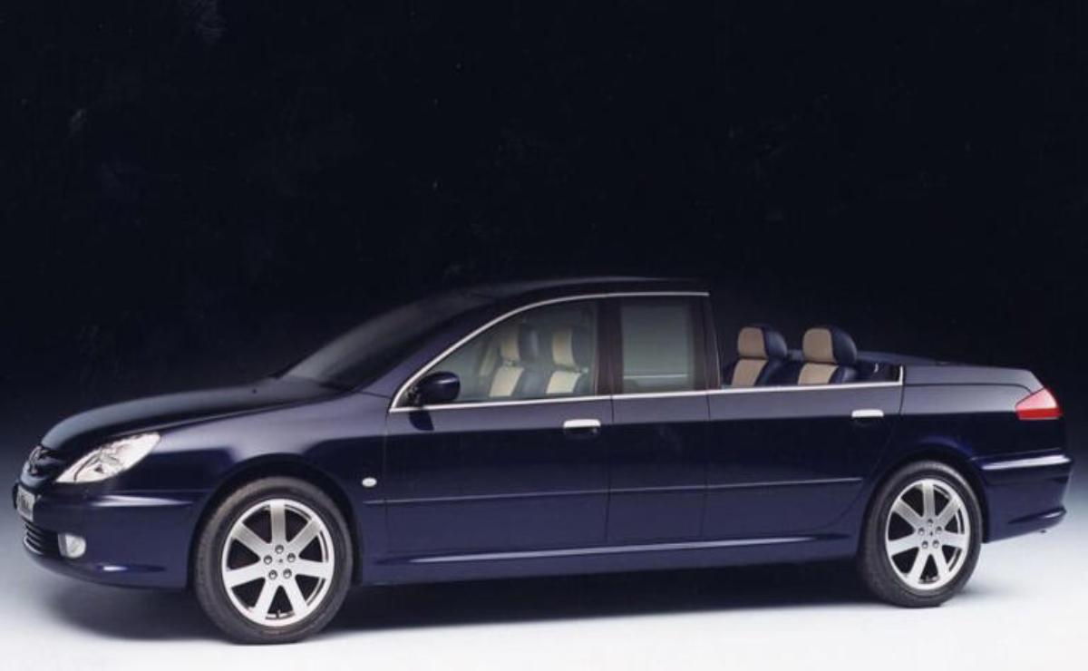 Side view of a sleek black sedan with beige interior.
