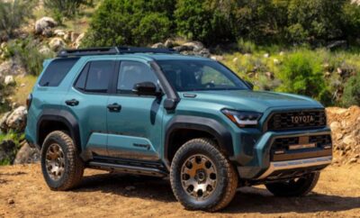 A rugged blue SUV parked outdoors in a natural setting.
