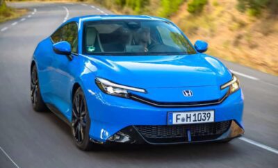 A sleek blue Honda electric car parked outdoors.