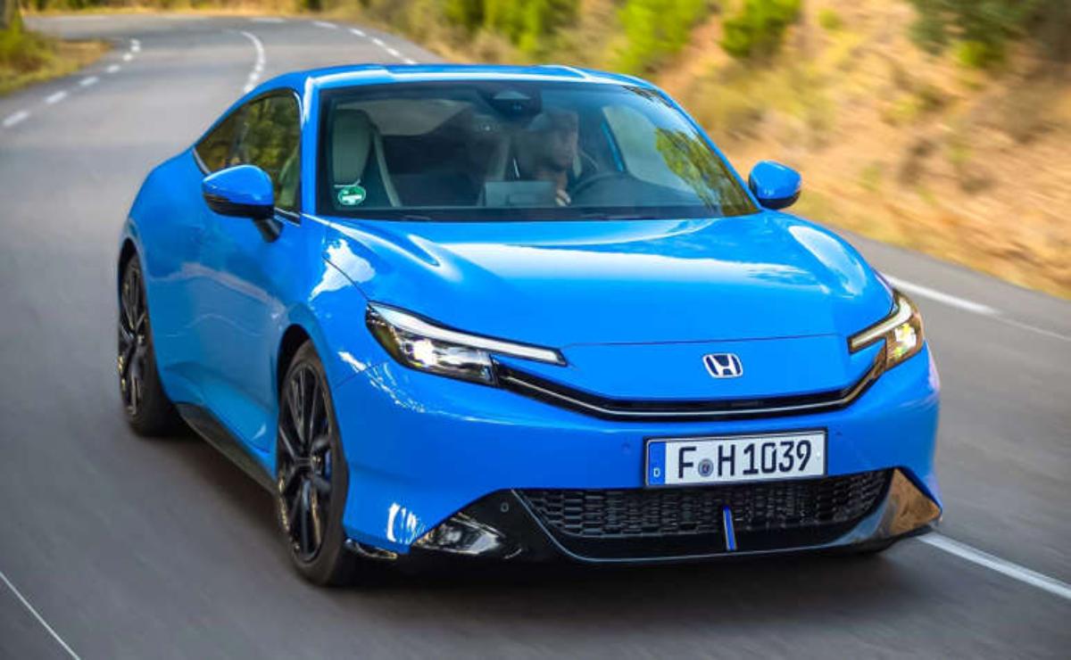 A sleek blue Honda electric car parked outdoors.