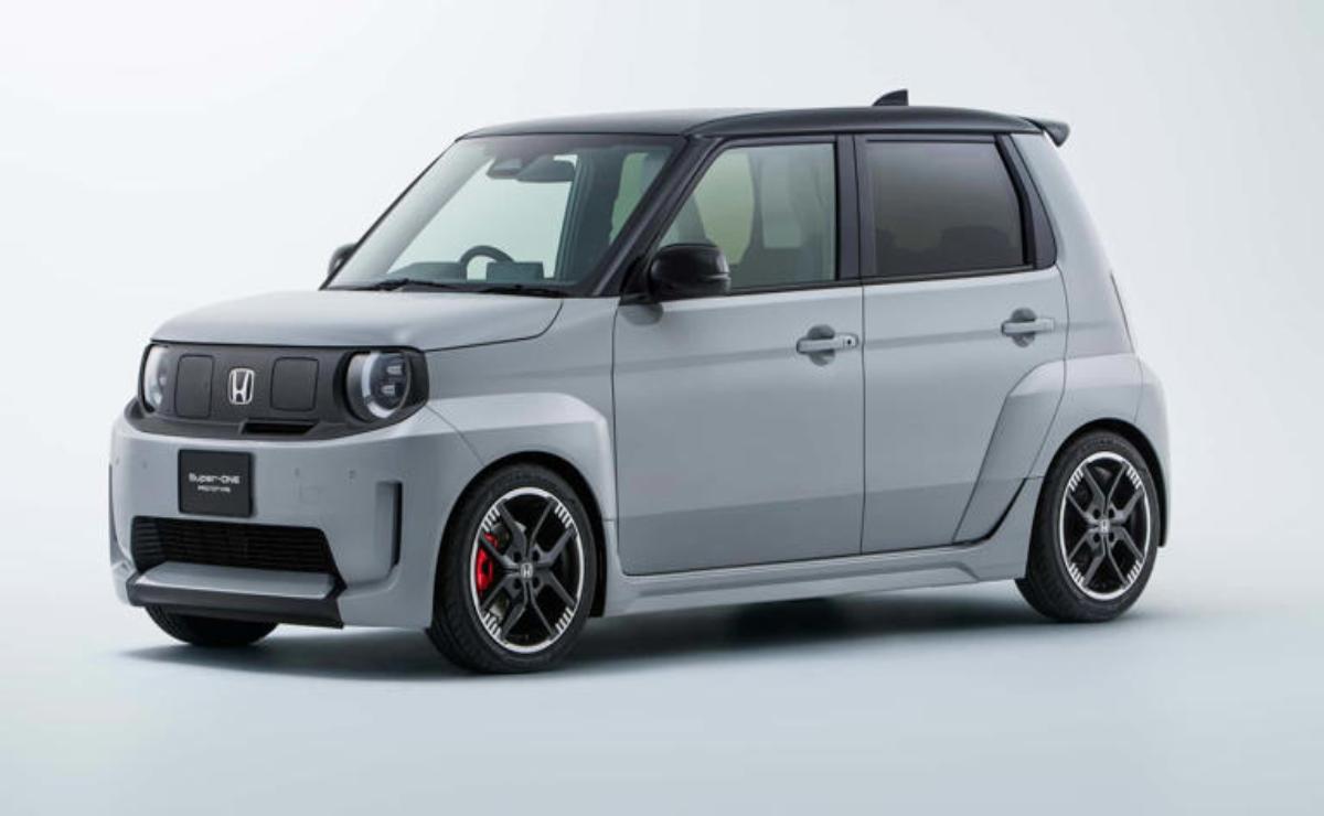 Compact silver hatchback car with black roof and sporty accents.