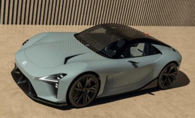 Sleek matte gray sports car parked in front of a modern building.