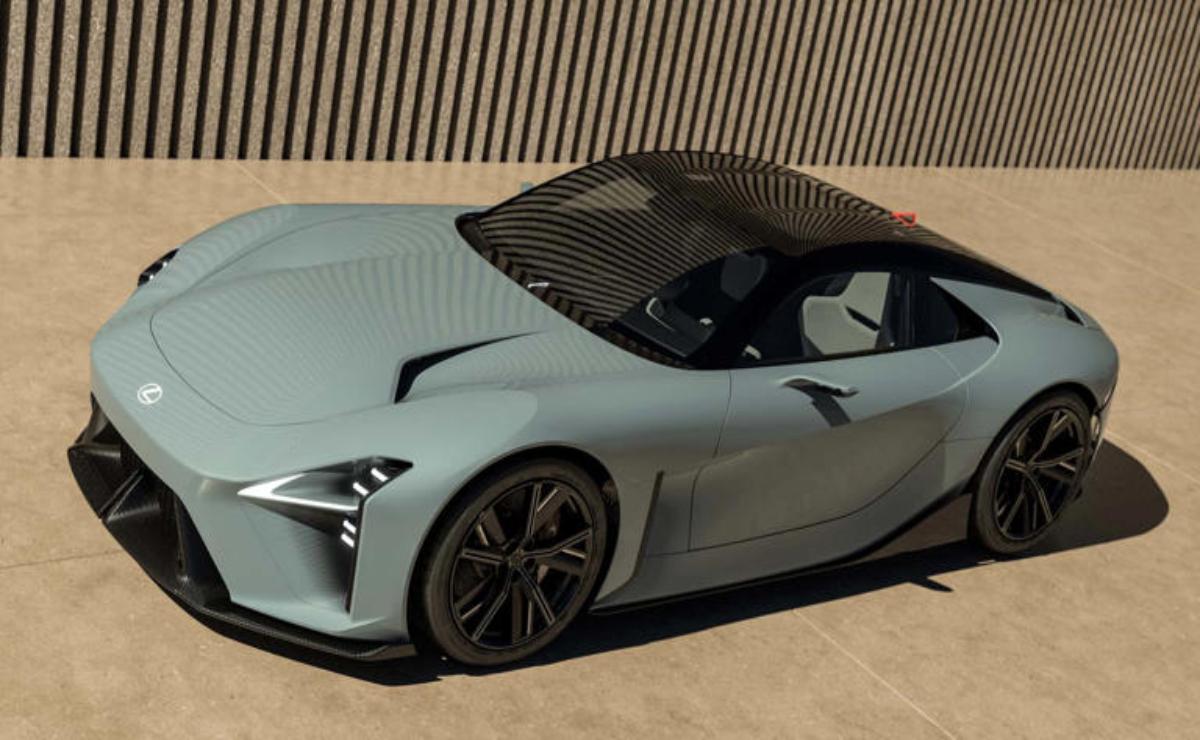 Sleek matte gray sports car parked in front of a modern building.