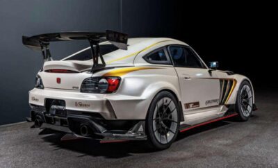 White sports car with aftermarket modifications in a studio setting.