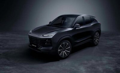 Sleek black modern SUV with tinted windows in a dimly lit setting.