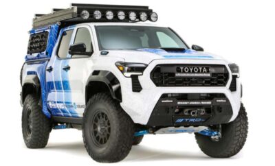 A rugged white Toyota off-road truck with large tires and additional lights.