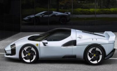 Sleek white sports car parked near a glass wall.