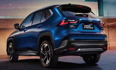 Rear view of a sleek blue Toyota Corolla Cross SUV in a studio setting.