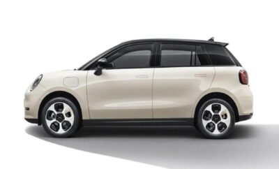 Side view of a modern white electric SUV with black roof and tinted windows.