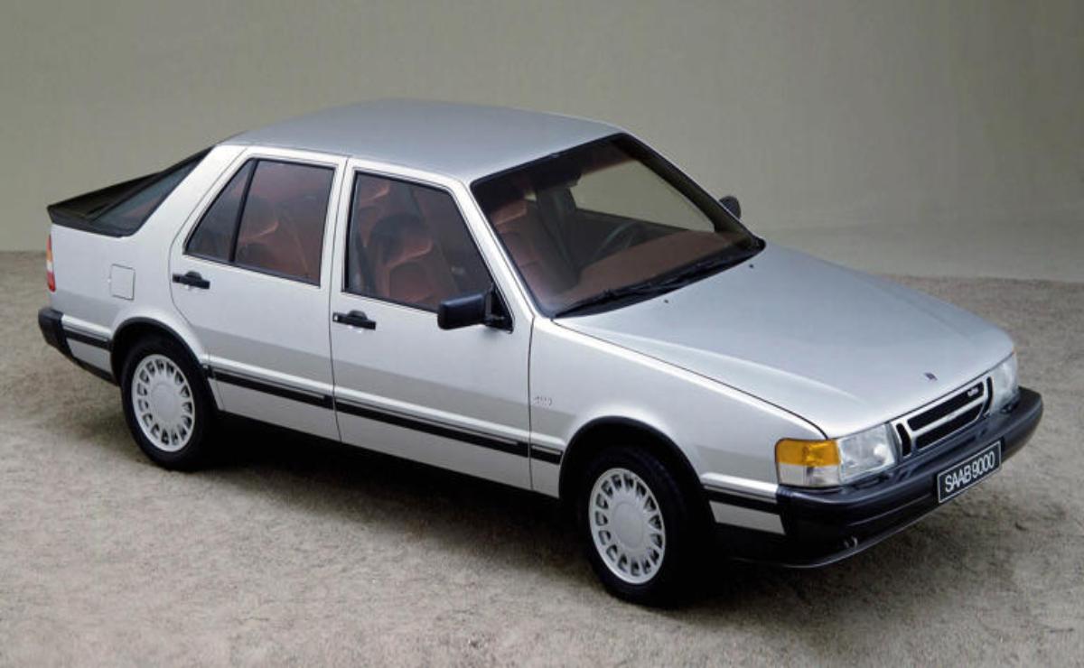 A silver four-door sedan parked on a gray surface.