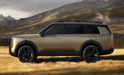 Side view of a sleek, modern SUV in a rugged outdoor setting.