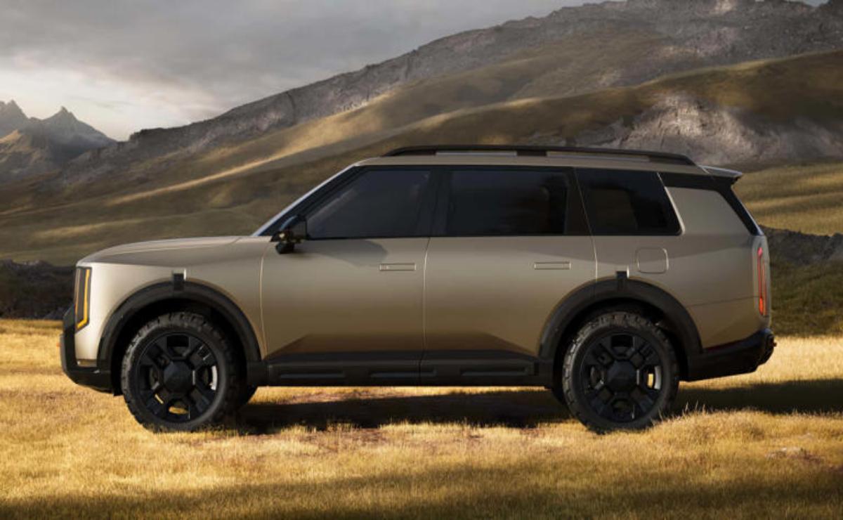 Side view of a sleek, modern SUV in a rugged outdoor setting.