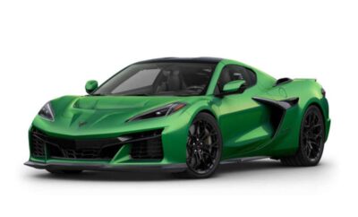 Green sports car with sleek design and black wheels.