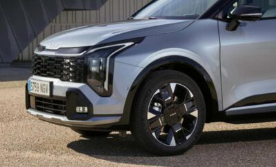 Close-up of a sleek modern car front and black wheel.