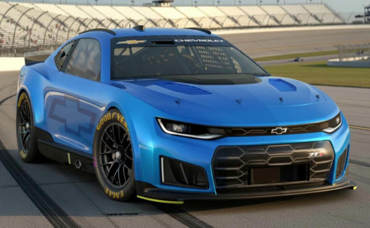 A sleek blue Chevrolet Camaro race car on a racetrack.