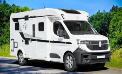 Modern white camper van parked outdoors under clear sky.
