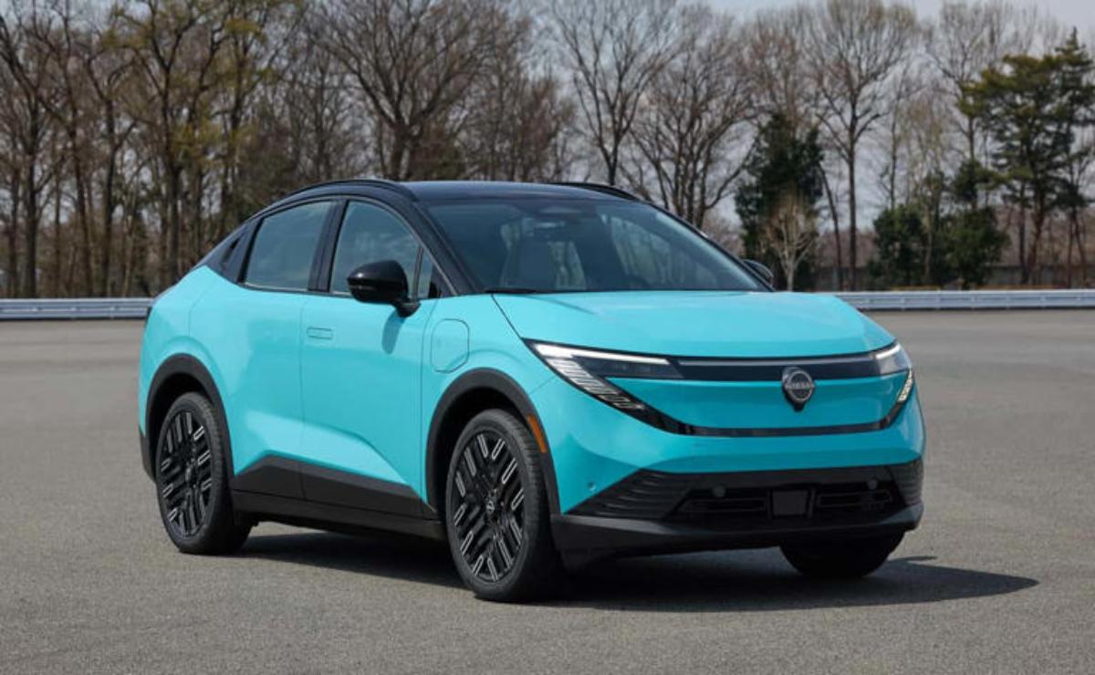 A sleek turquoise electric car parked outdoors with a modern design.