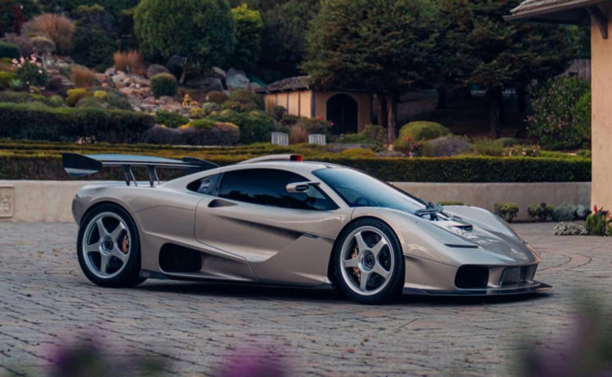 Sleek silver sports car parked on a scenic driveway.